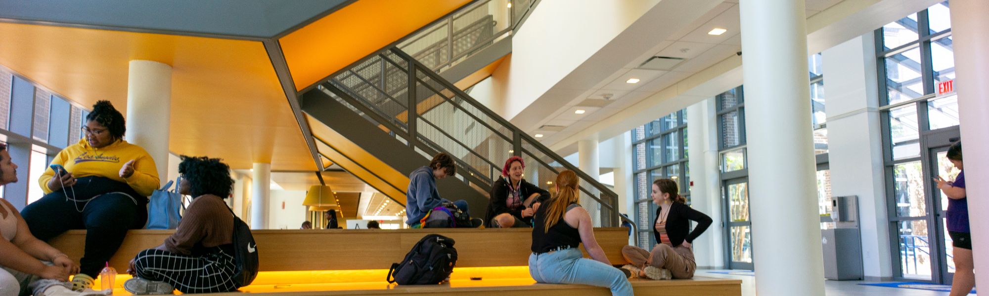 Students sitting around staircase in student union