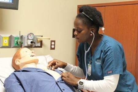 A student listening to heart sounds using a stethoscope