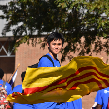 Student in international program waving yellow and red flag