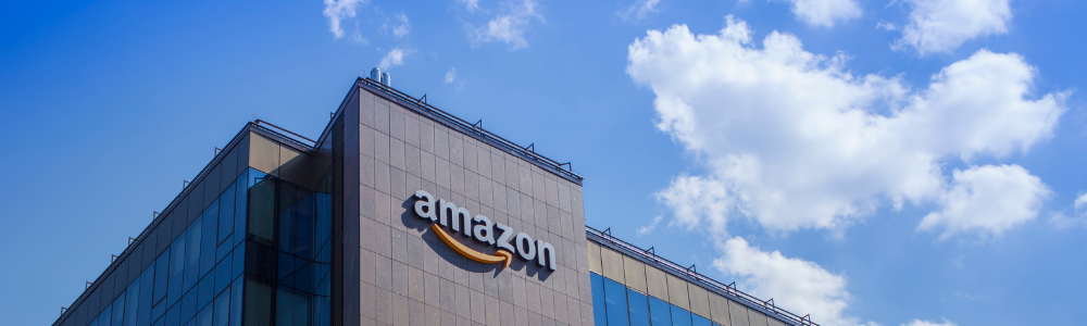 Wide shot of an Amazon building focused on their logo